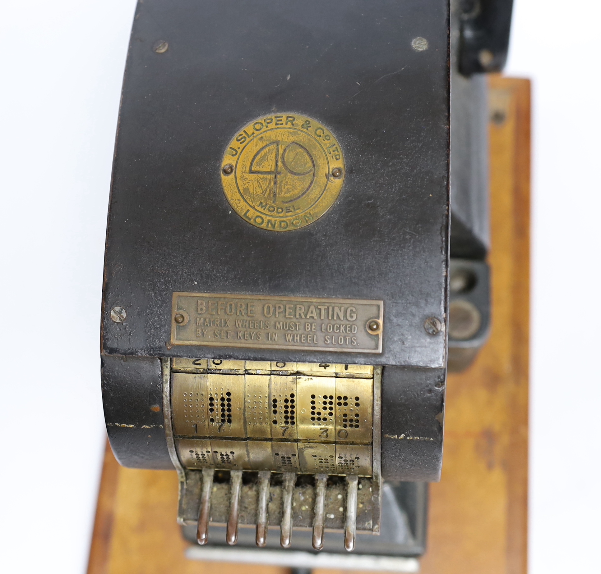 Two stamp perforators, a large example with adjustable date wheels and a smaller which stamps ‘& Co Not Negotiable’